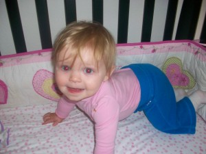 Pushing herself up into crawling position